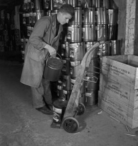 Apprentice at the warehouse with products of food company Mondamin, Germany 1940s. Apprentice at the warehouse with products of food company Mondamin, Germany 1940s.